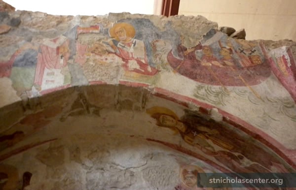 Two Nicholas scenes above arch Two Nicholas scenes above arch